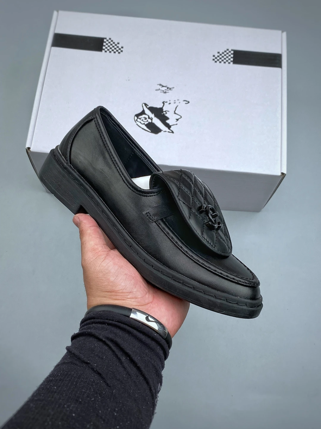 Black Chanel quilted leather loafers with a black CC turn-lock flap